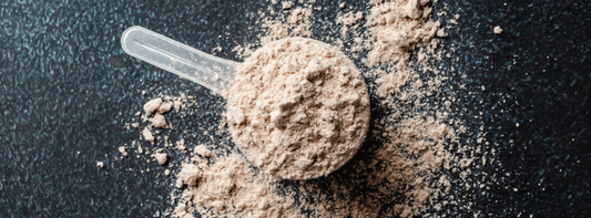 Protein powder with a scoop on a black background